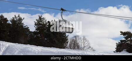 Panoramic view on chair-lift and snowy off-piste slope with traces from skis and snowboards in ski resort. Caucasus Mountains at winter. Tetnuldi, Sva Stock Photo