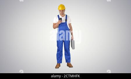 Factory worker employee chatting browsing texting on smartphone Stock Photo