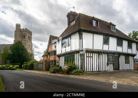 Smarden church and ancient timber-framed cottage in the village of Smarden, Kent, UK Stock Photo