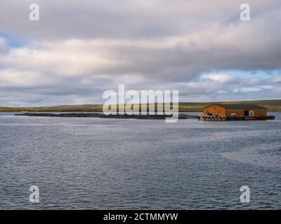 Aquaculture / fish farming in Bluemull Sound between the islands of Yell and Unst in Shetland - an archipelago of islands in the north of the UK Stock Photo