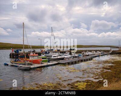 Fishing and leisure boats moored at Burravoe Marina on the south east of the island of Yell in Shetland, UK