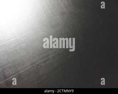 corrugated metal alloy as a background, metal surface, aluminum alloy, magnesium alloy, sun flare, grainy texture Stock Photo