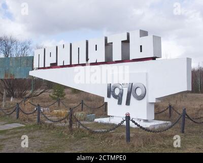 Chernobyl exclusion zone. Ruins of abandoned Pripyat city. Autumn in zone of exclusion. Pripyat sign. Text in russian: Pripyat (name of the city). Stock Photo