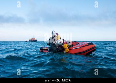 The Severn Class Penlee Lifeboat Ivan Ellen with the small inshore inflatable recovering a casualty Stock Photo