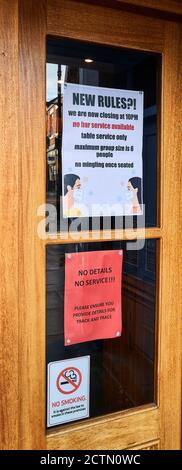 Notice on the door of a bar at Kettering, Northants, England (24 September 2020), about new rules to prevent the spread of covid-19. Stock Photo