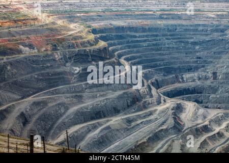 Giant iron ore quarry in Rudny, Kazakhstan. Open pit mine. Mining raw minerals for steel production. Stock Photo