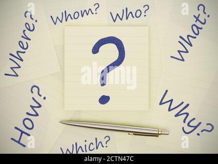 Adhesive notes with question marks on wood Stock Photo