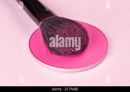 Professional make-up brush and face powder on pink Stock Photo