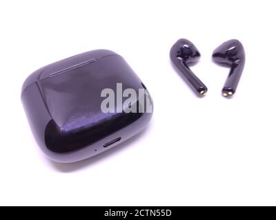 Black wireless headphone with case isolated on white background. Selective focus Stock Photo