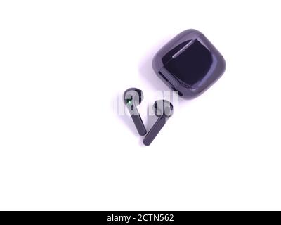 Black wireless headphone with case isolated on white background. Selective focus Stock Photo
