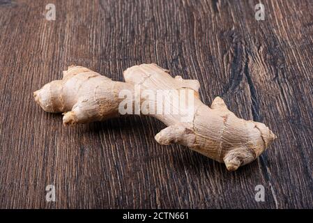 Fresh ginger root on a wooden surface. Close up. Copy space. Stock Photo