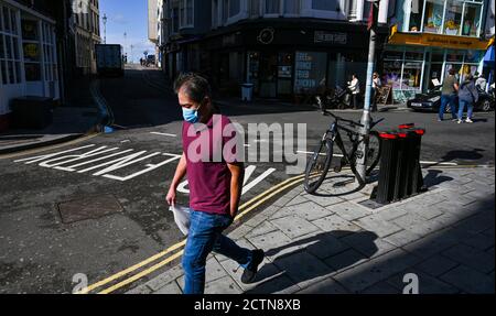 Brighton UK 24th September 2020 - Shoppers in Brighton some wearing face masks as the new government COVID restrictions are brought in throughout England today with pubs and restaurants having to close at 10pm tonight : Credit Simon Dack / Alamy Live News Stock Photo