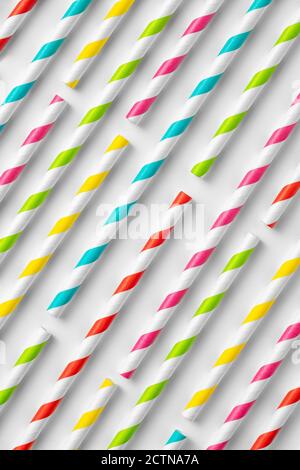 Top view flat lay composition of multicolored striped plastic straws for drinks arranged on white background Stock Photo
