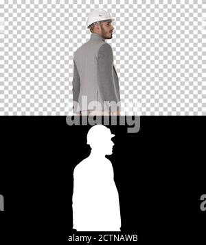 Walking engineer in helmet, Alpha Channel Stock Photo