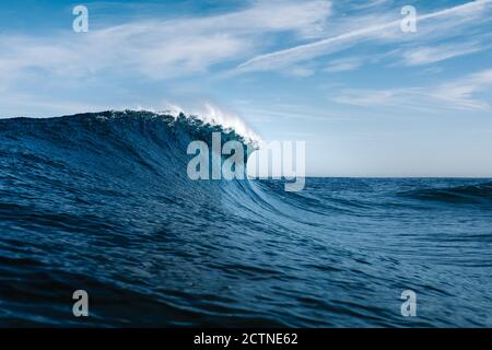 Powerful blue breaking ocean waves with white foam Stock Photo