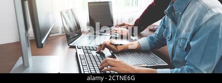 Team of Programmer working to find solution to problem and coding technologies in a software developing company office Stock Photo