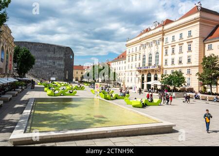 Vienna, Austria – May 24, 2017. View of Museumsplatz in the Museumsquartier in Vienna, toward Mumok and Hofstallungen complex, with people. Stock Photo
