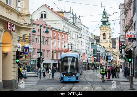 Linz, Austria – May 25, 2017. Street view on Landstrasse street in Linz, with tram, commercial properties and people. Stock Photo