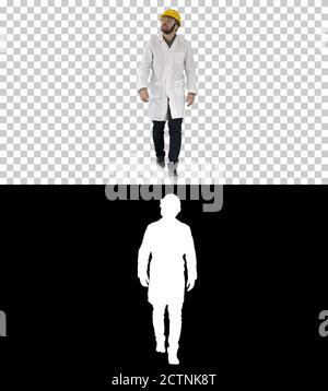 Engineer putting on protactive glasses while walking, Alpha Chan Stock Photo