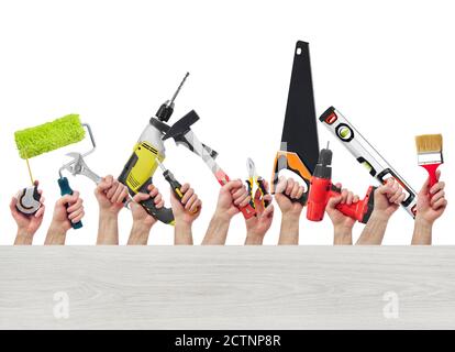 Hands raised holding different tools with copy space Stock Photo