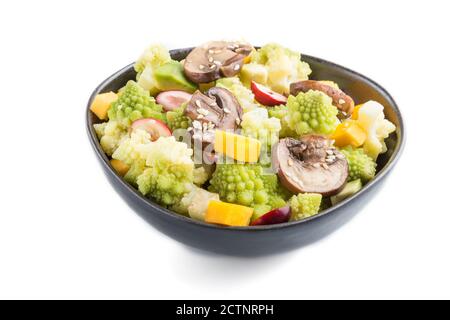 Vegetarian salad from romanesco cabbage, champignons, cranberry, avocado and pumpkin in black bowl isolated on a white background. side view, close up Stock Photo