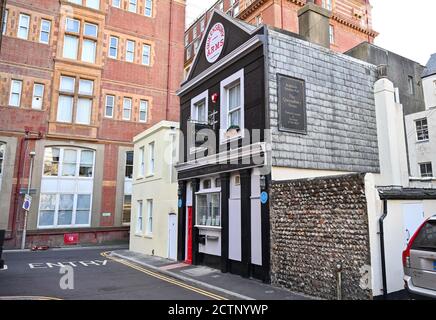 The Queensbury Arms formerly known as The Hole in the Wall is Brighton's smallest pub tucked behind the Metropole Hilton Hotel which is up for sale UK Stock Photo