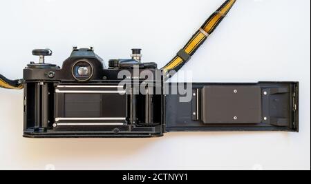 Back of Nikon FE SLR film camera body with open back cover. Stock Photo