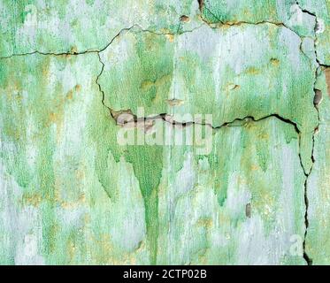 Green painted damaged grunge wall background or texture Stock Photo
