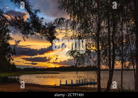 Amazing sunset at the Braslaw lakes with the cloudy sky. Braslaw district, Belarus. Stock Photo
