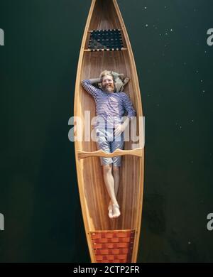 Smiling bearded man relaxing in the boat Stock Photo
