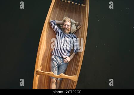 Single man relaxing in the canoe Stock Photo