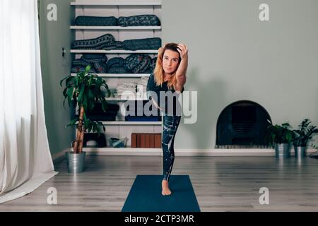 front view of a woman with long hair doing the workout on a yoga mat - sport and healthy lifestyle concept Stock Photo