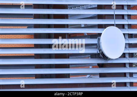 Satellite dish on the grid construction close-up Stock Photo