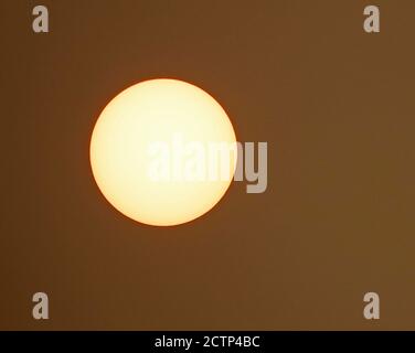 The sun, mostly blocked by smoke from the massive forest fires burning in the Cascade Range in the Pacific Northwest. This image was taken in Oregon i Stock Photo