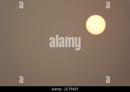 The sun, mostly blocked by smoke from the massive forest fires burning in the Cascade Range in the Pacific Northwest. This image was taken in Oregon i Stock Photo