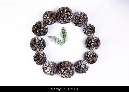 Christmas time concept. Mock Christmas clock and watch made of pine cone and fir branches. Holiday and New Year decoration. Stock Photo