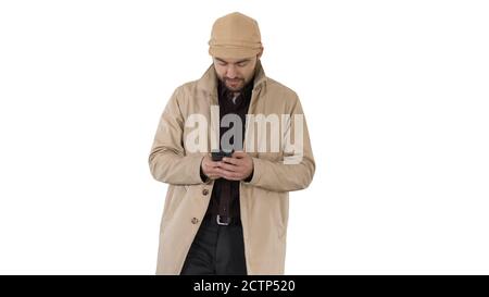 Young handsome man in cloak messaging with phone on white backgr Stock Photo