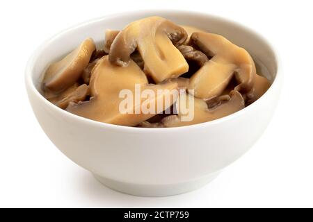 Canned sliced button mushrooms in a white ceramic bowl isolated on white. Stock Photo