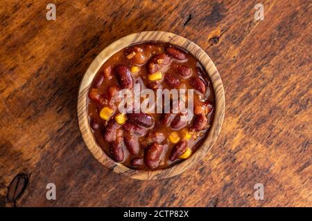 Chili con carne. Mexican food with beans in wooden bowl. Top view. Stock Photo