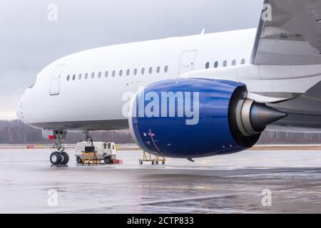Aircraft engine and aircraft fuselage nose in airfield Stock Photo