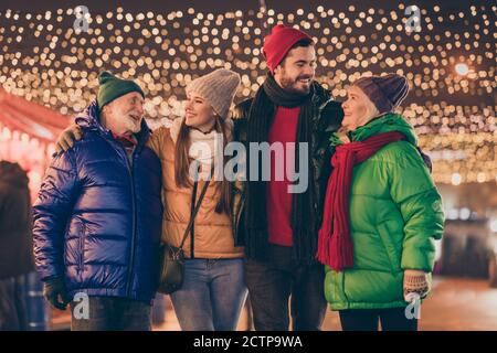 Photo of full family four members meeting embrace spend noel weekend together after long parting newyear miracle buy souvenirs multi-generation night Stock Photo