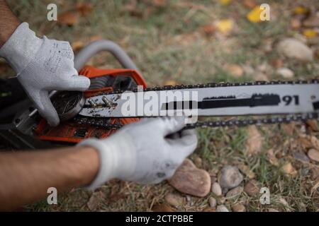 Closeup of a lumberjack with a chainsaw in a forest Stock Photo