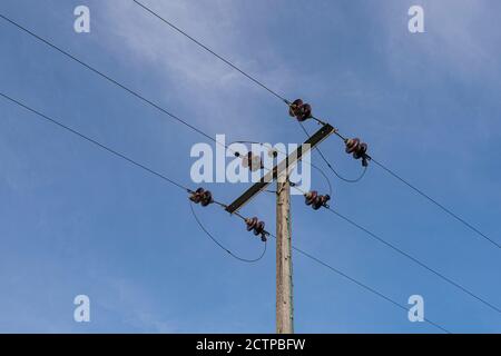 electricity supply cables against a blue sky Stock Photo