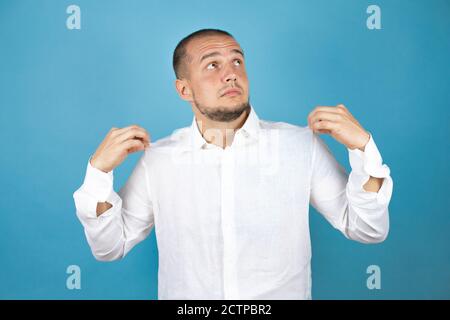 Russian business man wearing white shirt standing over blue background with a successful expression