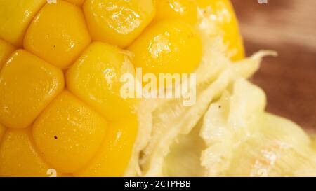 Delicious corn on the cob captured in an extreme close up. The brightly glowing yellow kernels form a recognizable pattern. Stock Photo