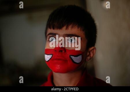 Gaza, Palestine. 23rd Sep, 2020. A young boy is seen after getting his mask painted on her face.Nineteen-year-old Ranin Al Zeriei paints mask on her face in Deir Al Balah town Southern Gaza strip amid the ongoing coronavirus COVID-19 pandemic. Credit: SOPA Images Limited/Alamy Live News Stock Photo