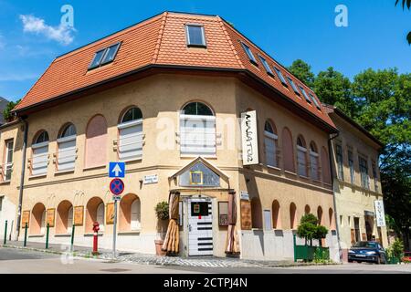 Budapest, Hungary – June 5, 2017.  Historic building in Budapest, housing commercial properties, with car. Stock Photo