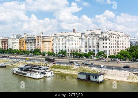 Budapest, Hungary – June 6, 2017.  Street view on Carl Lutz rkp. avenue in Budapest, with cruising boats, residential buildings and people. Stock Photo