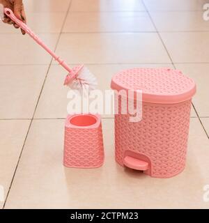 Pink toilet brush and holder, trash bin isolated Stock Photo