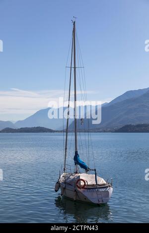Yacht moored on an apparent empty Lake Como at Gravedona, Lombardy, Italy. Stock Photo